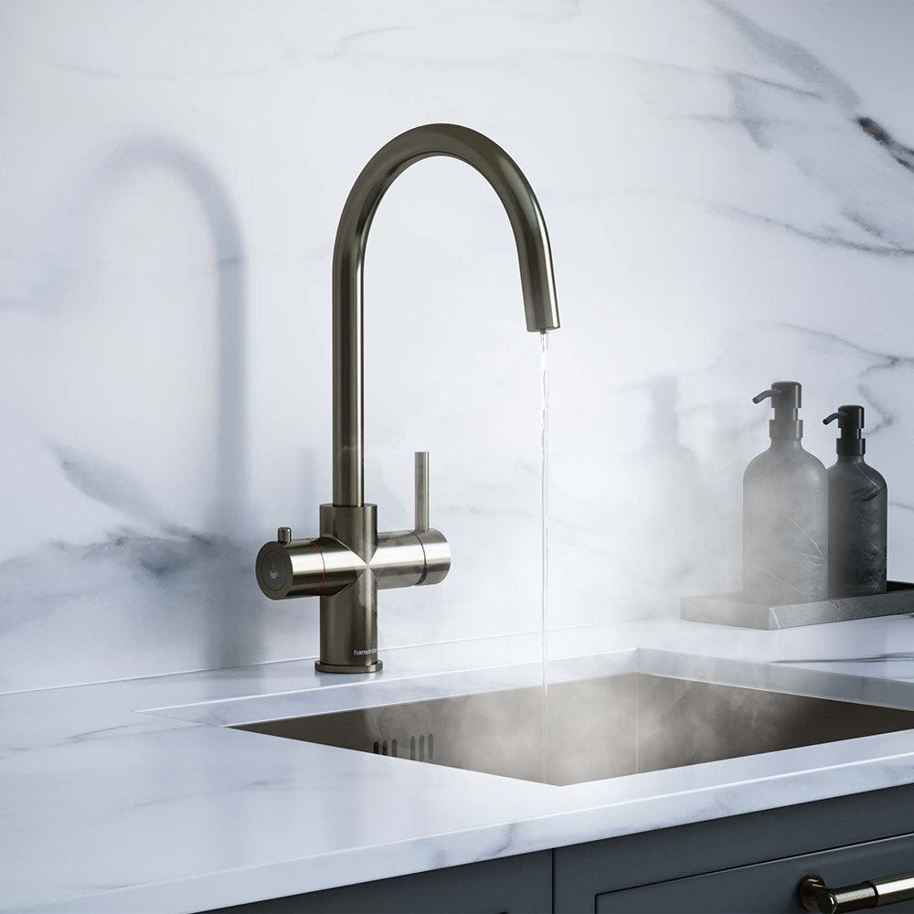 a gunmetal grey swan neck boiling water tap on a white kitchen countertop