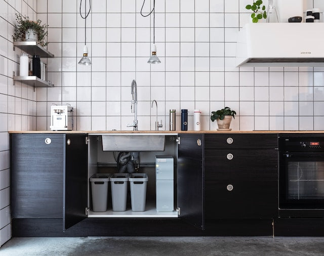 modern kitchen with white chequered tiles and black cabinets