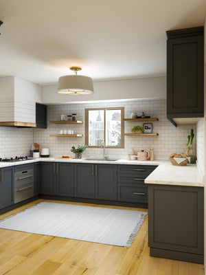 bright u-shaped kitchen with white worktops and grey cupboards