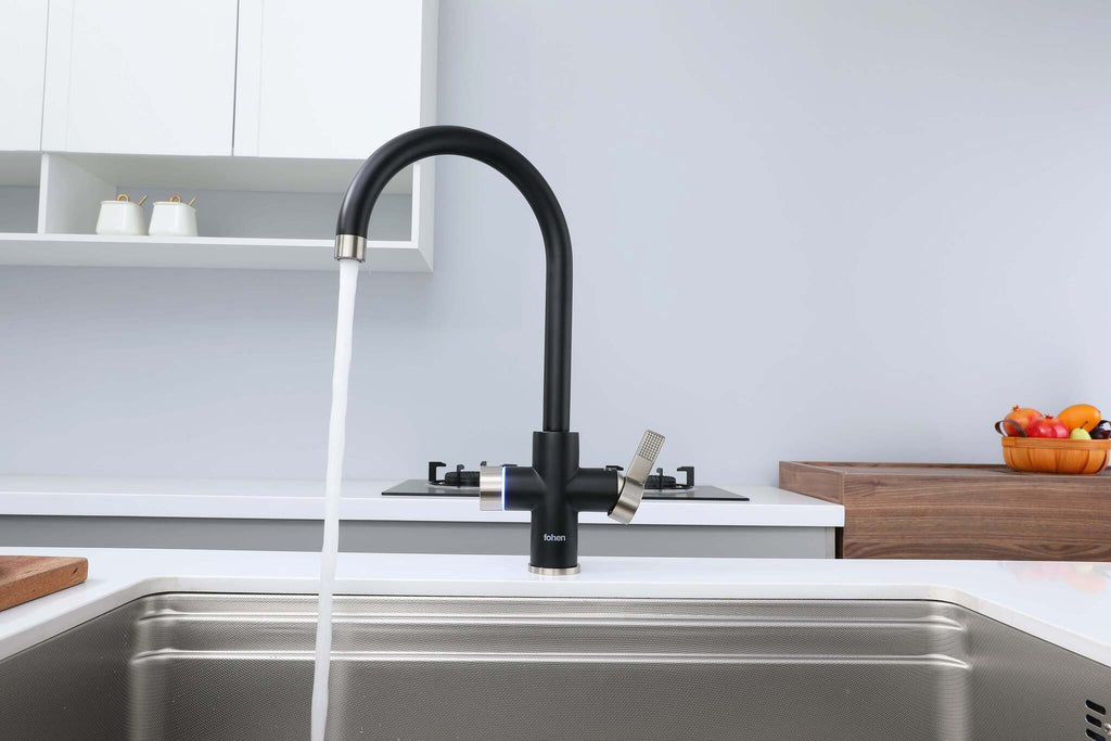 Black kitchen faucet with water flowing into a sink in a modern kitchen.