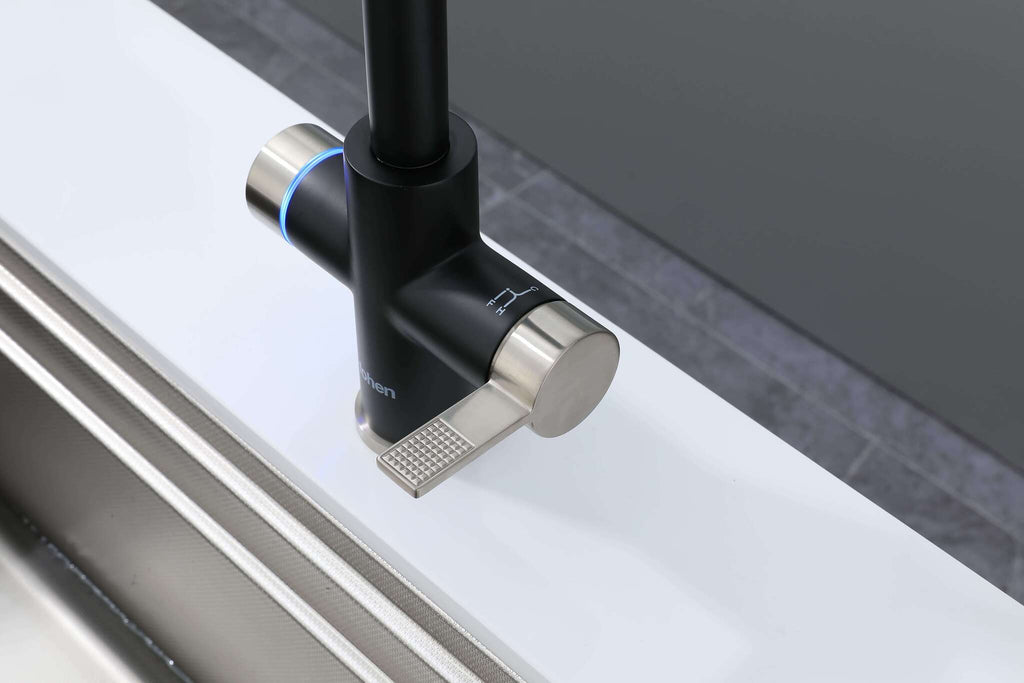 Modern kitchen faucet with black and silver design on a white countertop.
