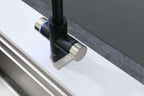 Modern kitchen faucet with black and silver design on a white countertop.