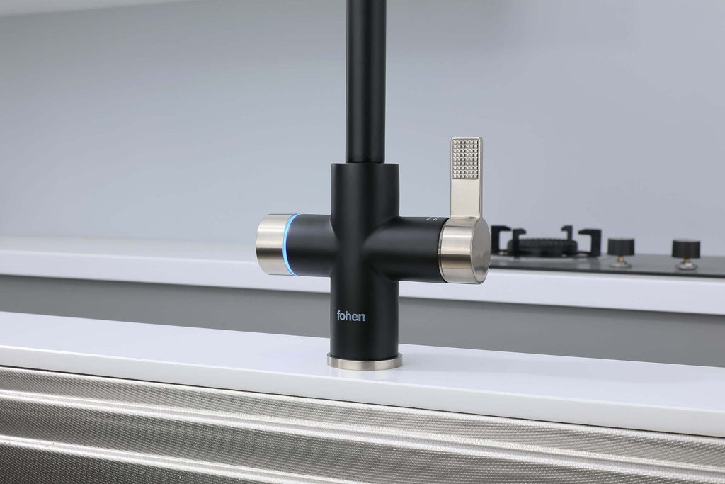 Black kitchen faucet with silver handles on a white countertop