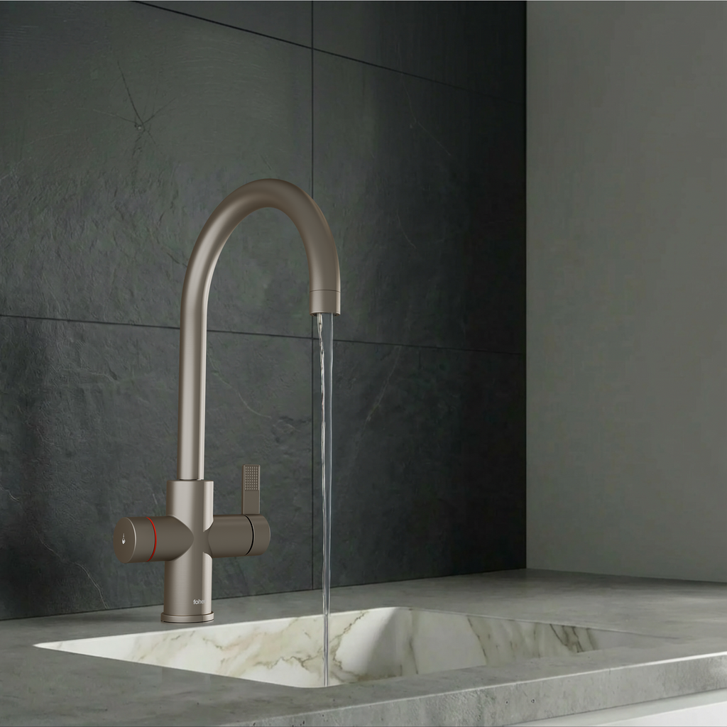 Modern kitchen faucet with a metallic finish in a dark tiled bathroom.