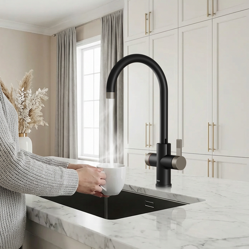 Person washing a white mug under a black kitchen faucet in a modern kitchen.