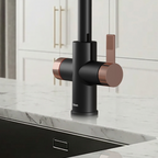 Modern kitchen faucet with black and copper design on a marble countertop.