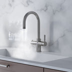 a chrome swan neck boiling water tap on a white kitchen countertop