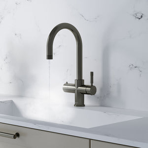 a swan neck gunmetal grey boiling water tap on a white kitchen countertop