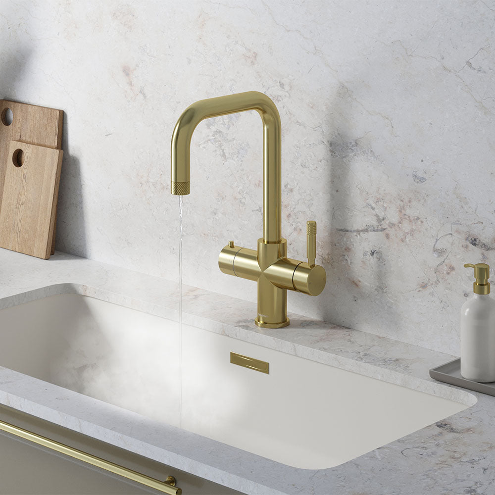 a square-shaped champagne gold boiling water tap on a white kitchen countertop
