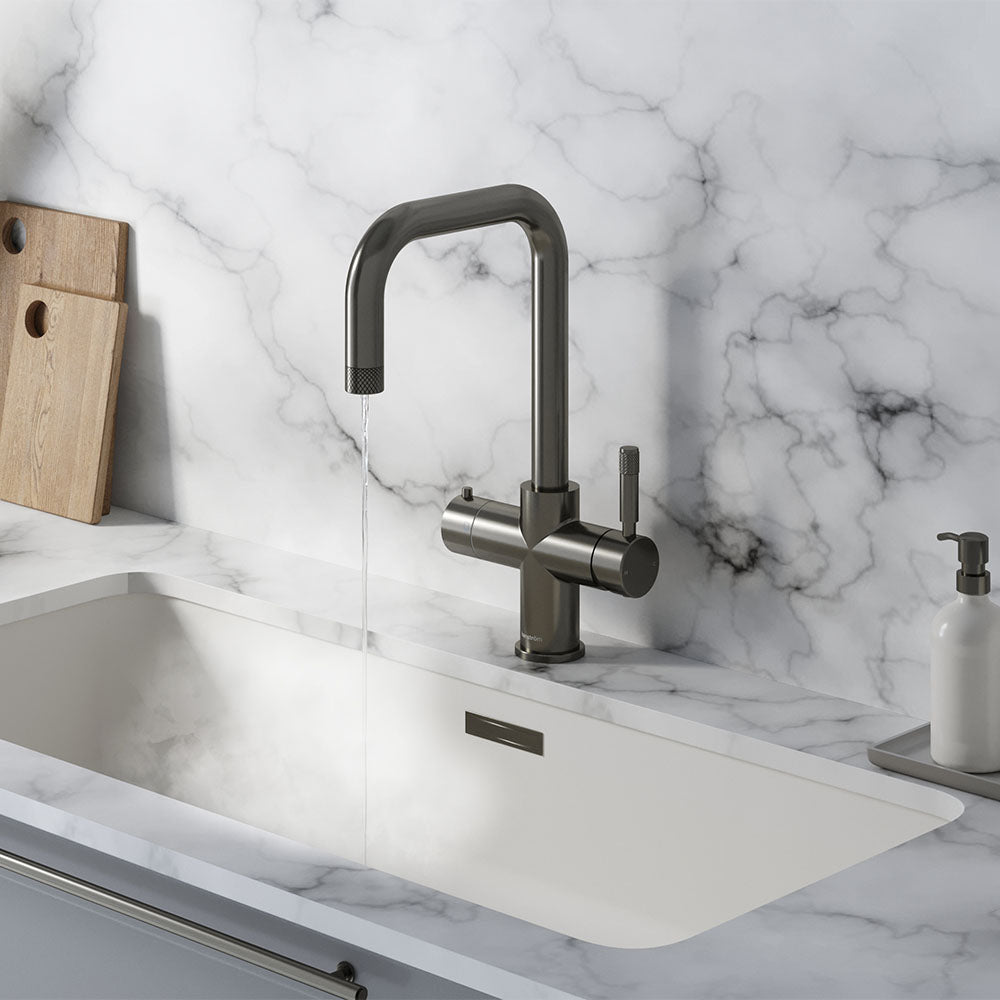 a square-shaped gunmetal grey boiling water tap on a white kitchen countertop