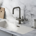 a square-shaped gunmetal grey boiling water tap on a white kitchen countertop