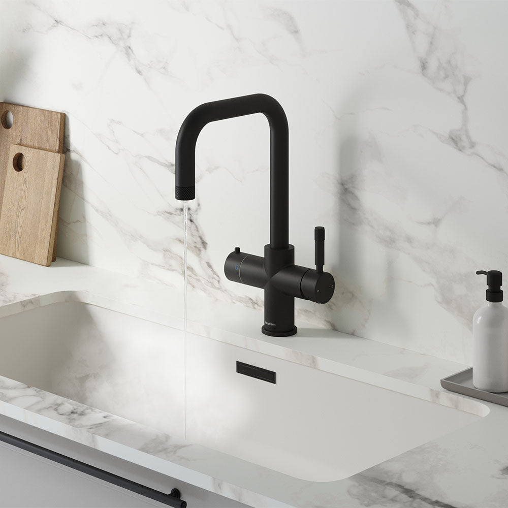 a square-shaped matt black boiling water tap on a white kitchen countertop