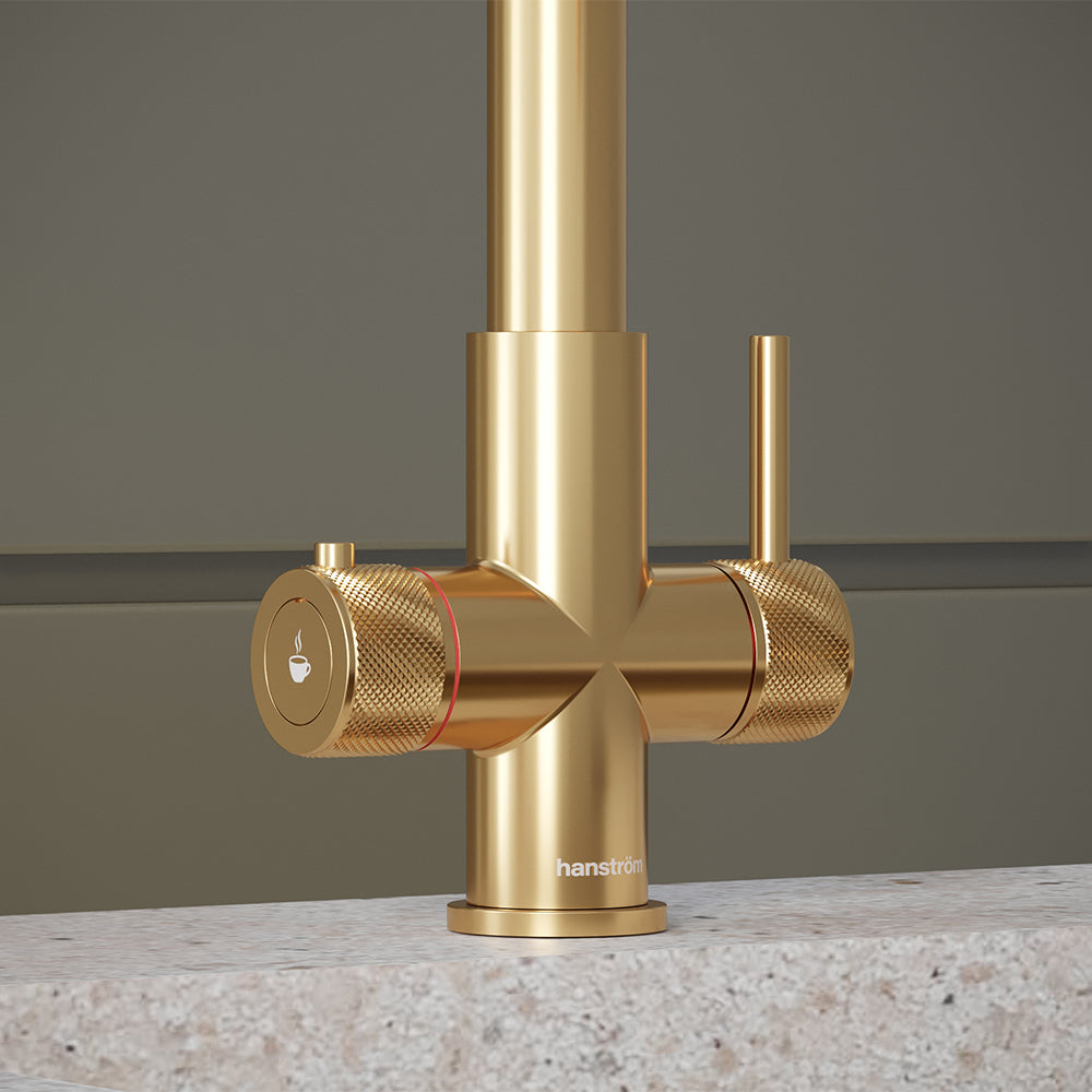 close-up of a brushed gold hot tap handle