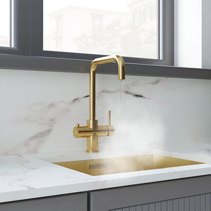 a square-shaped brushed gold boiling water tap on a white kitchen countertop