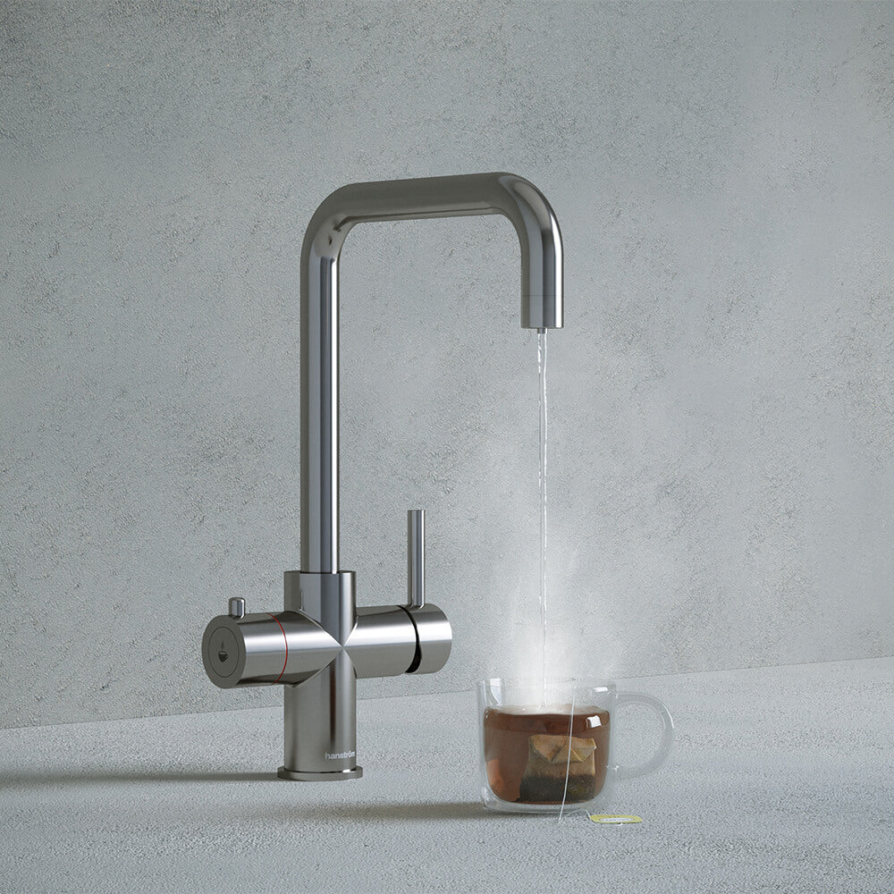 a chrome square-shaped boiling water tap dispensing hot water to a cup of tea