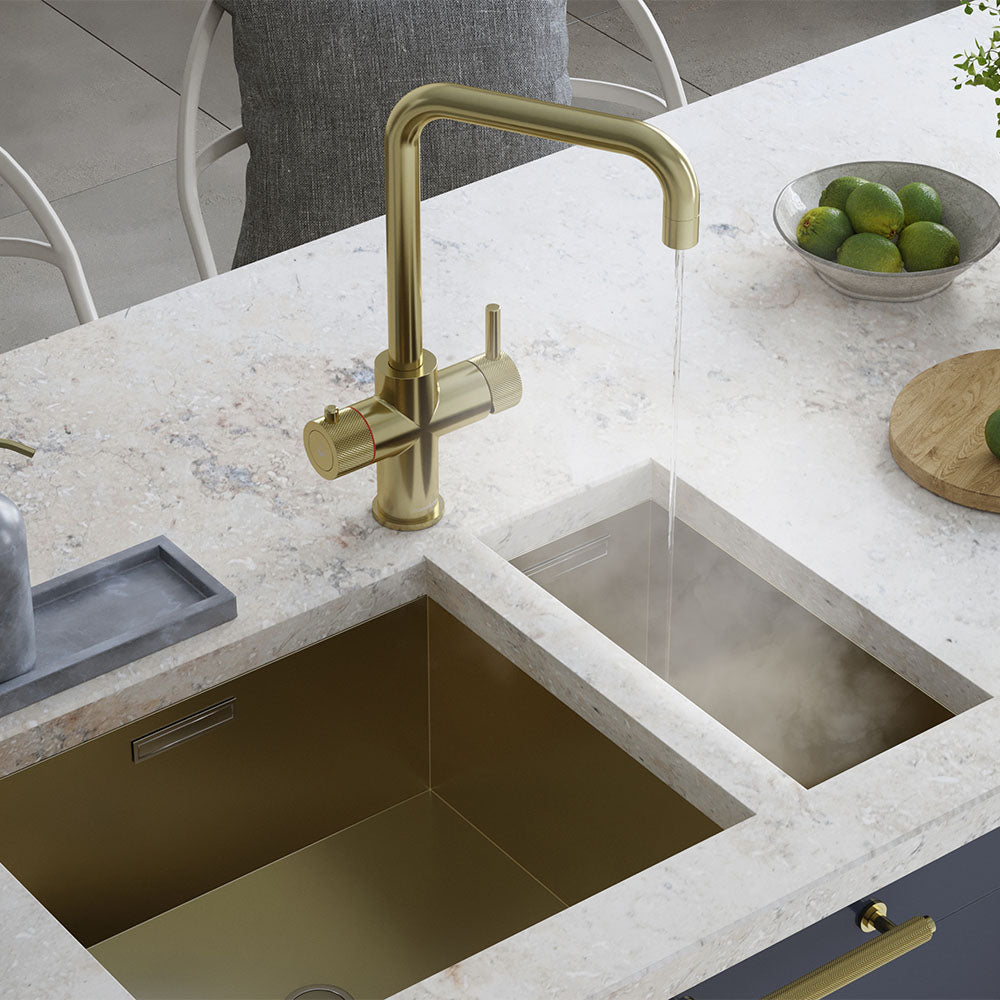 a brass square-shaped boiling water tap on a white kitchen countertop