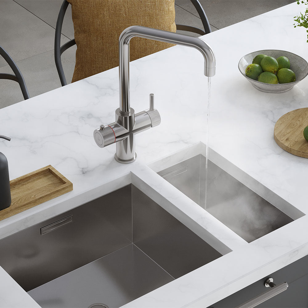 a chrome square-shaped boiling water tap on a white kitchen countertop