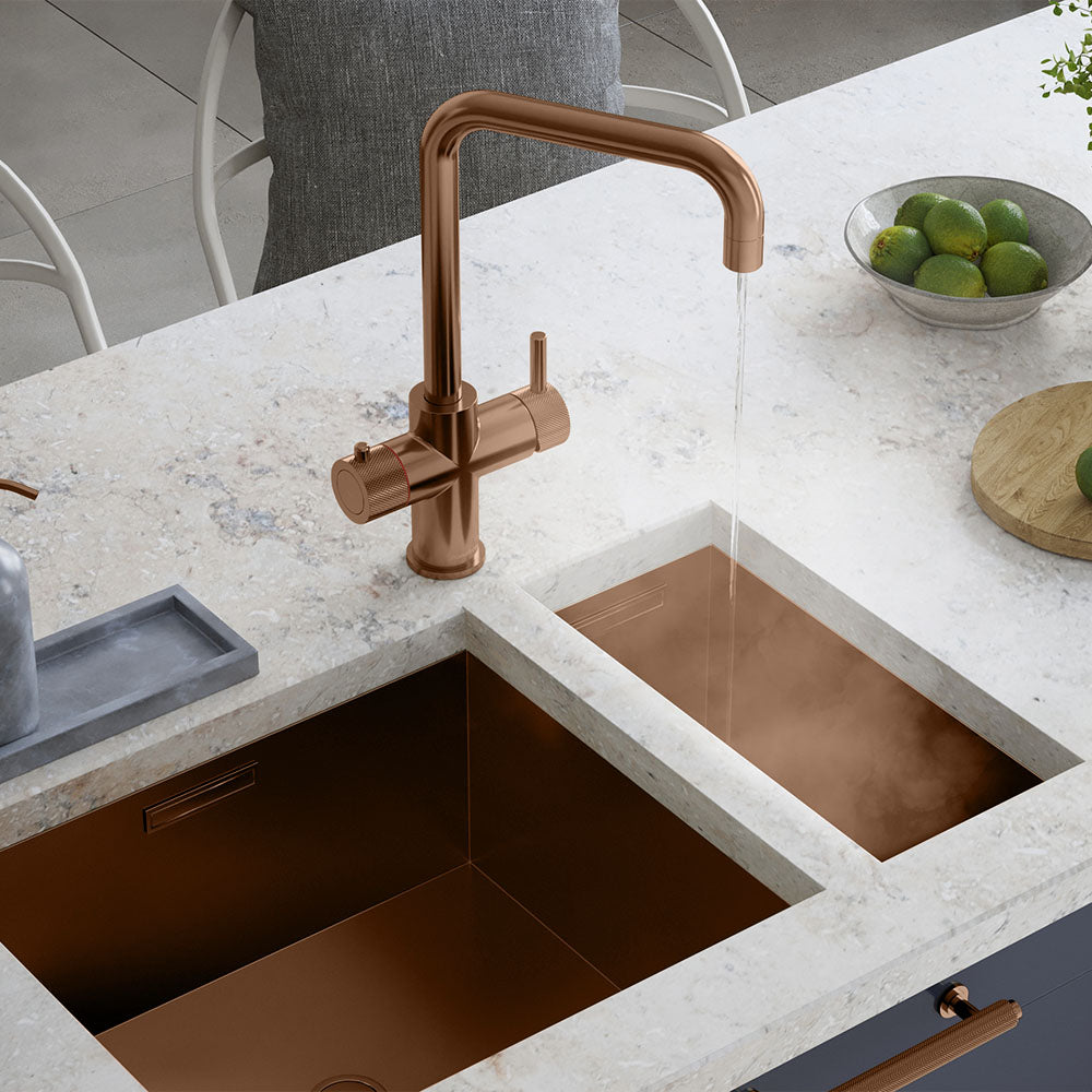 a square-shaped copper boiling water tap on a white kitchen countertop