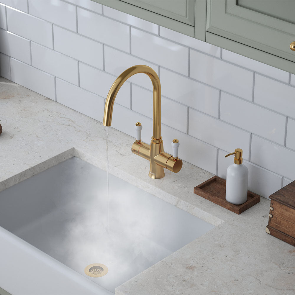 a traditional brushed gold swan neck hot tap with white handle