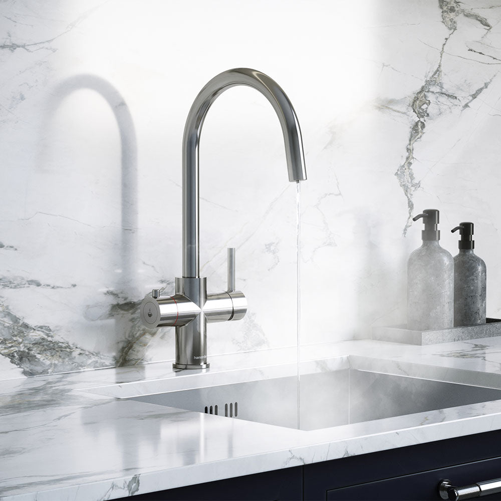 a chrome swan neck boiling water tap on a white kitchen countertop