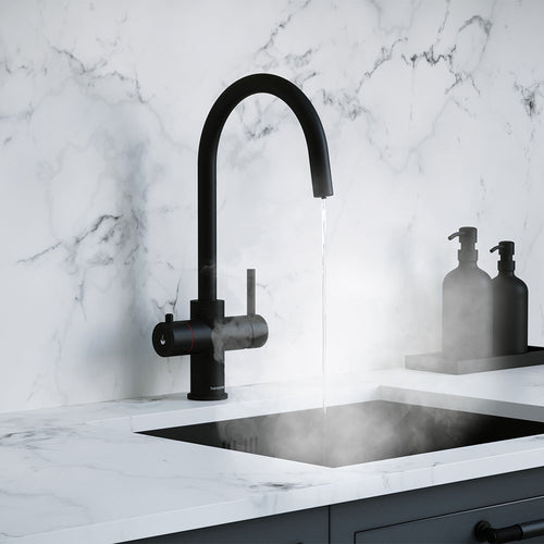 a matt black swan neck boiling water tap on a white kitchen countertop
