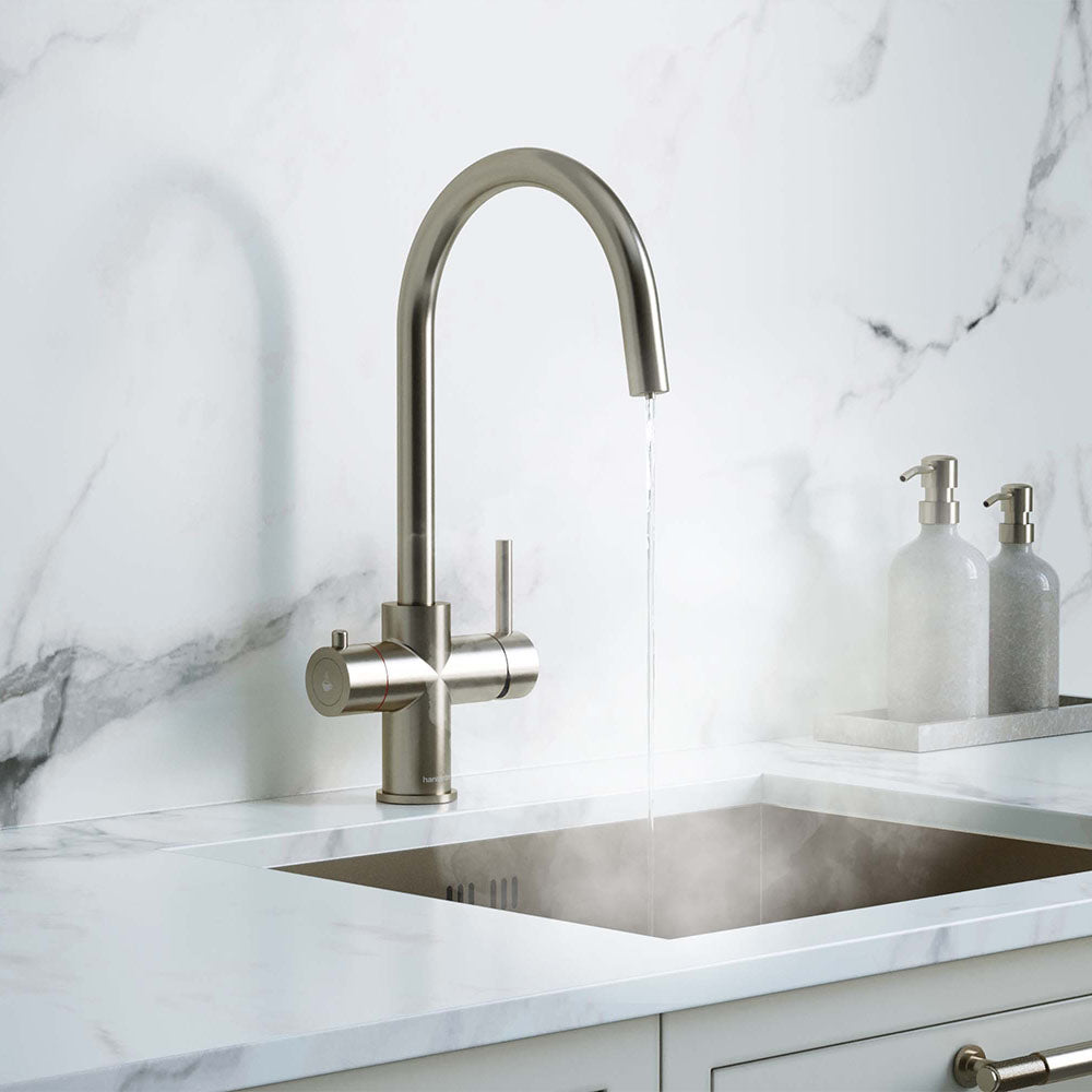 a brushed nickel swan neck boiling water tap on a white kitchen countertop
