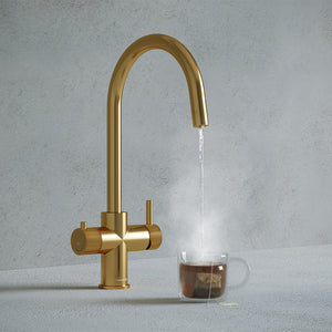 a brushed gold swan neck boiling water tap