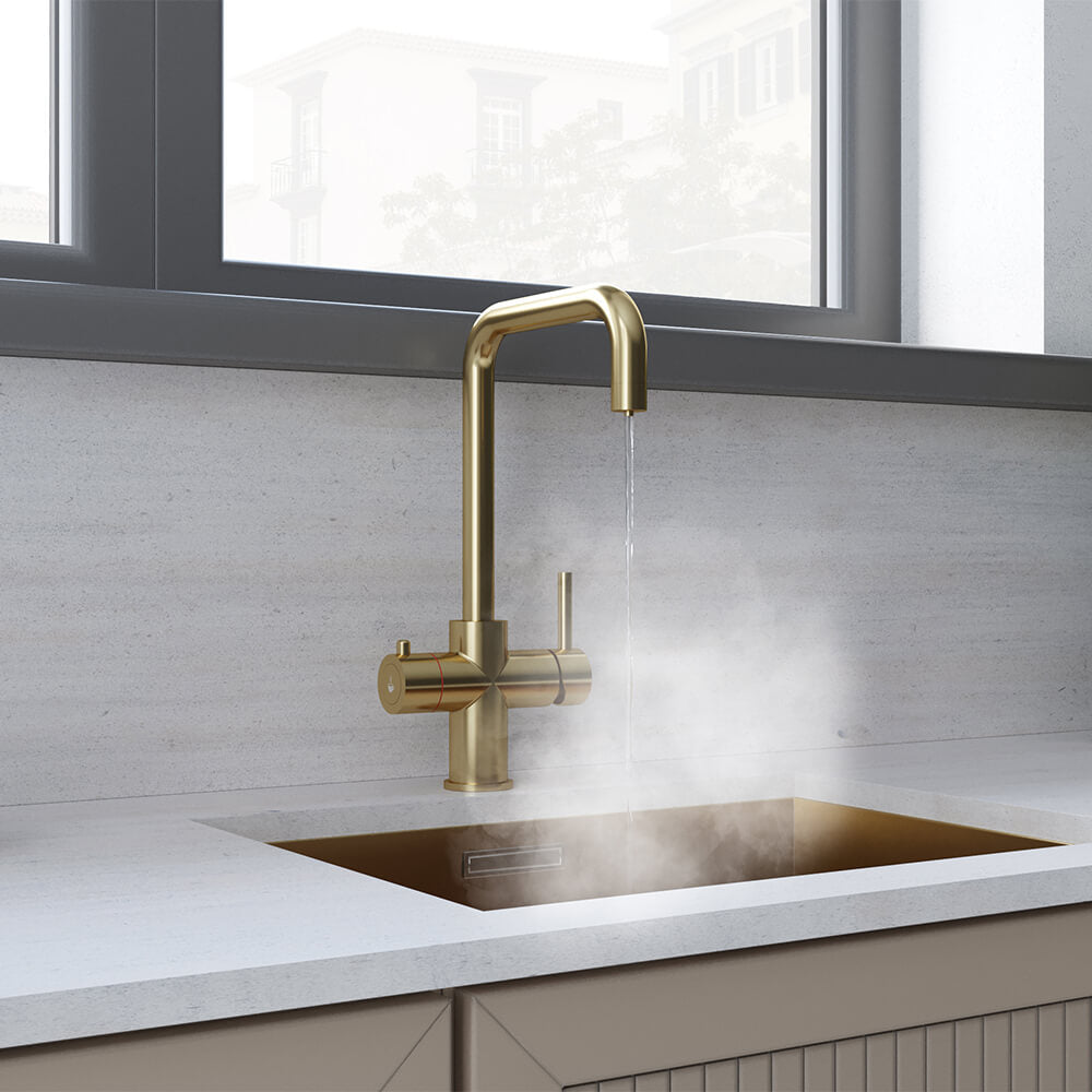 a brass square-shaped boiling water tap dispensing hot water